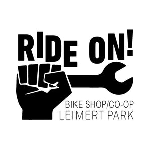 The Ride On! Logo is a black fist holding a wrench. With the words Ride On! Showing movement above the fist and wrench. The shop is located in historic Leimert Park Village